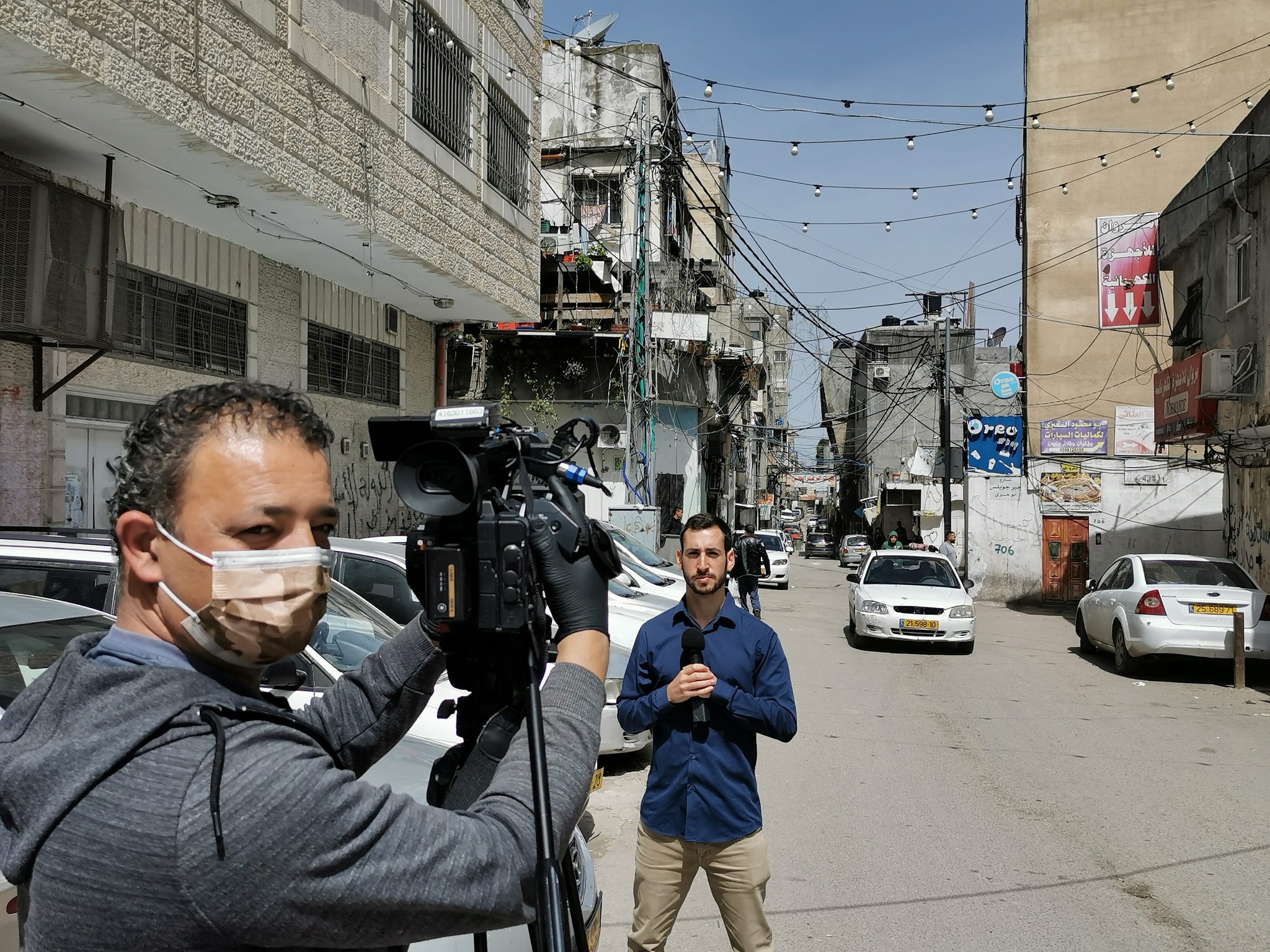 Adi Koplewitz reporting on location with a camera crew